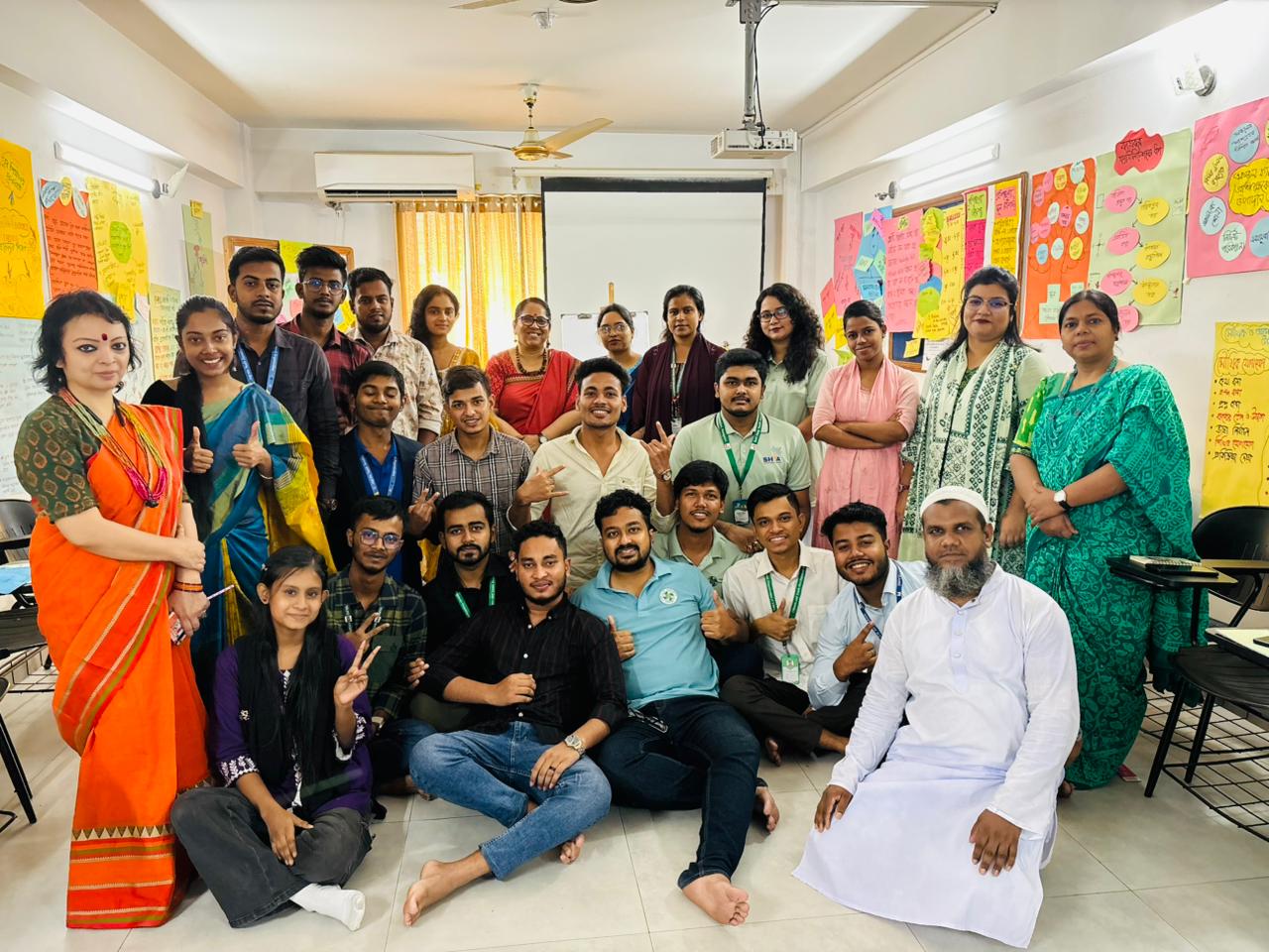 
Workshop participants posing with trainers, ready to empower their community.